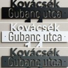 Három fém házszámtábla egymás mellett: fekete, fehér és antracit porfestéssel
